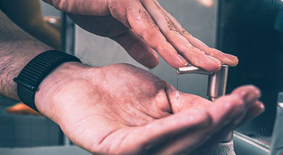 Bild på manliga händer som tvättar sig med tvål.
